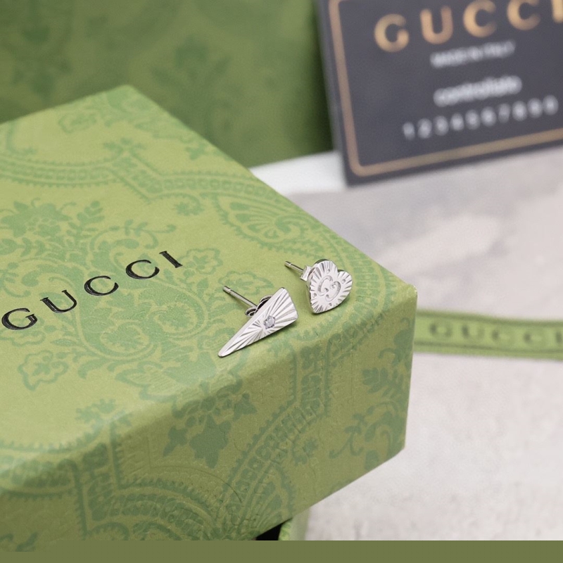 G*u*i earrings